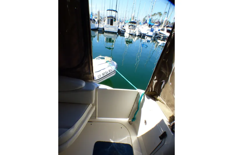 Slide: The Image of 2002 Sea Ray 340 Sundancer interior view with marina backdrop. - 35