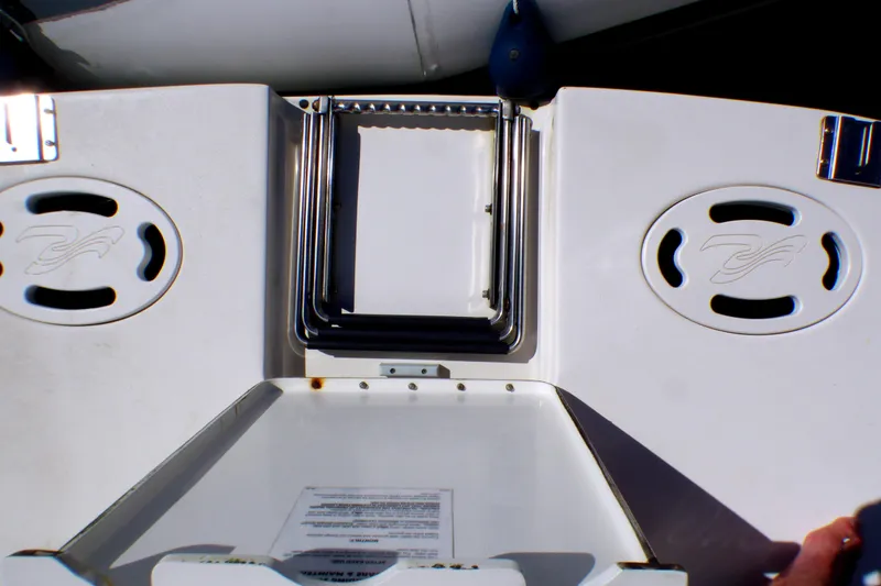 Slide: The Image of 2002 Sea Ray 340 Sundancer boat deck with storage compartments and logo details. - 36