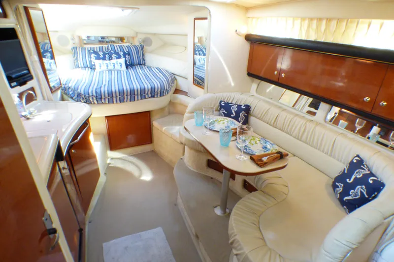 Slide: The Image of Luxurious interior of 2002 Sea Ray 340 Sundancer with cozy seating and elegant dining area. - 4