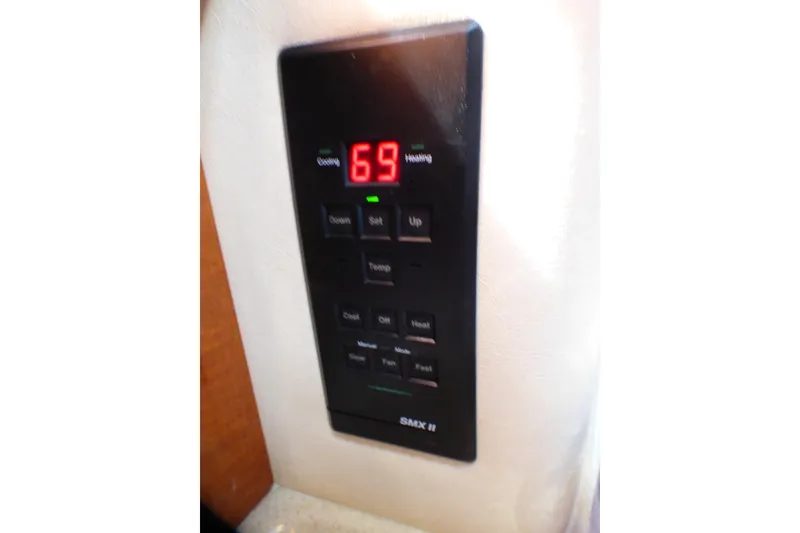 Slide: The Image of Digital thermostat panel on 2002 Sea Ray 340 Sundancer boat, displaying 69 degrees. - 45