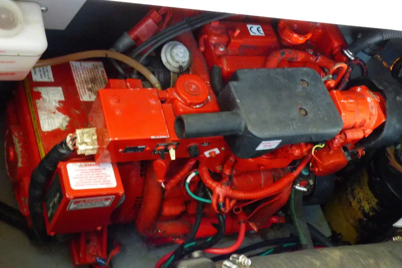 Slide: The Image of Engine compartment of a 2002 Sea Ray 340 Sundancer boat, featuring red components. - 49
