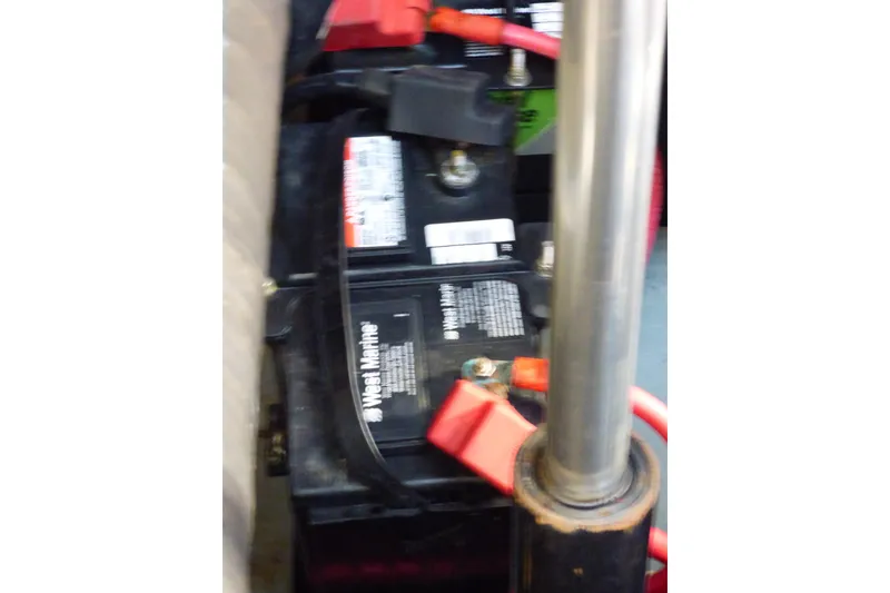 Slide: The Image of Battery compartment of 2002 Sea Ray 340 Sundancer with red cables and marine battery. - 51