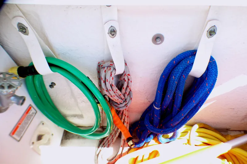 Slide: The Image of Colorful ropes and hose stored on a 2002 Sea Ray 340 Sundancer boat. - 53