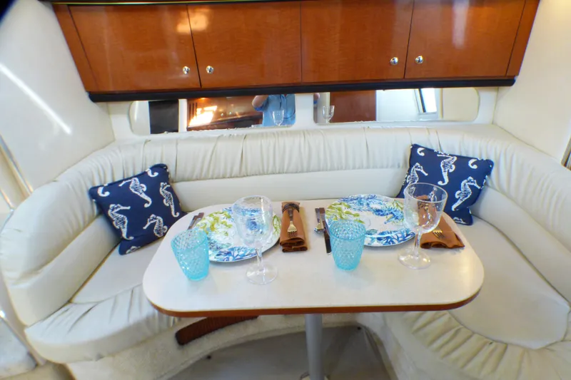 Slide: The Image of Luxurious dining area inside 2002 Sea Ray 340 Sundancer yacht with elegant table setting. - 6