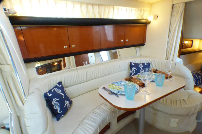 Slide: The Image of Luxurious interior of 2002 Sea Ray 340 Sundancer yacht with elegant dining setup. - 7