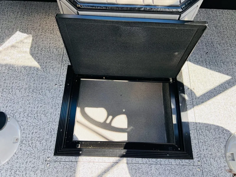 Slide: The Image of Open storage compartment on a 2026 Starcraft Delta 178 DC boat. - 21