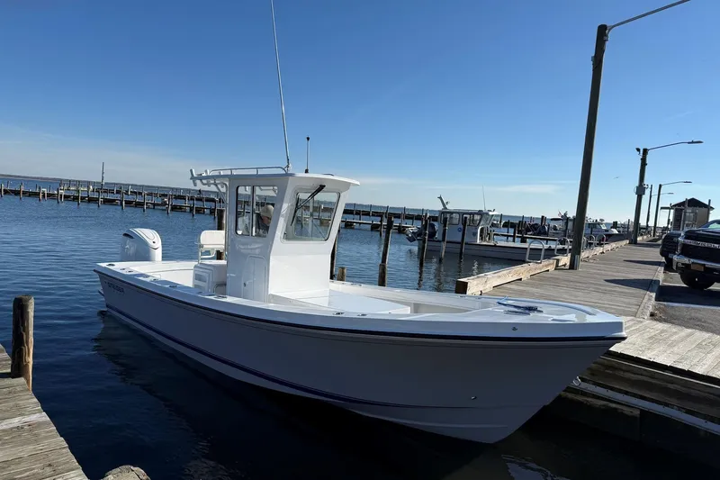 Slide: The Image of 2026 Steiger Craft 255 Chatham boat docked at a marina under clear skies. - 4