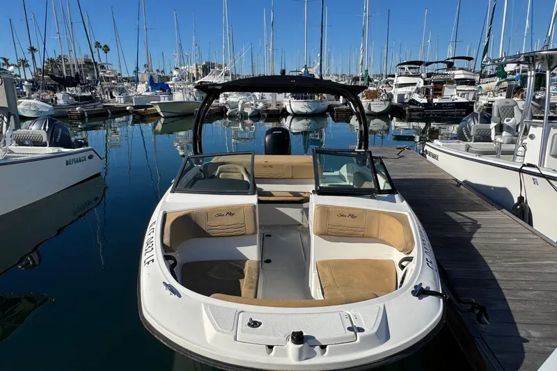 Slide: The Image of 2022 Sea Ray SPX 190 Outboard boat docked in a marina with sailboats. - 10