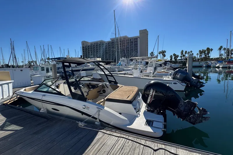 Slide: The Image of 2022 Sea Ray SPX 190 Outboard docked at marina under clear blue sky. - 13