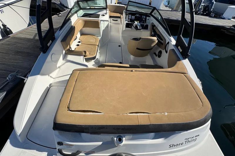 Slide: The Image of 2022 Sea Ray SPX 190 Outboard boat with tan seating, docked at marina. - 16