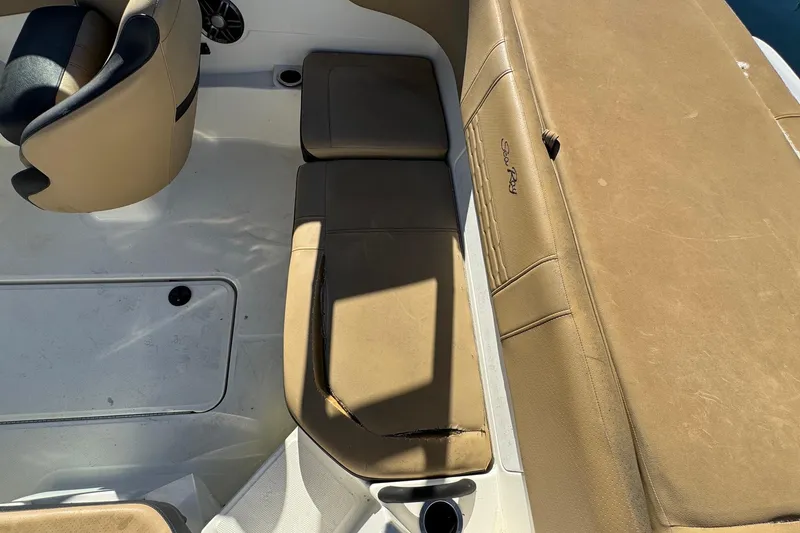 Slide: The Image of 2022 Sea Ray SPX 190 Outboard interior seating with tan upholstery and cup holder. - 19