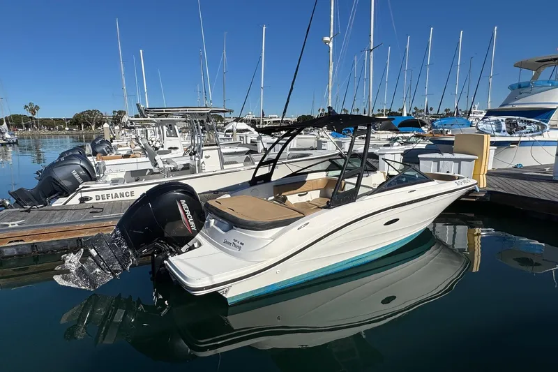 Slide: The Image of 2022 Sea Ray SPX 190 Outboard boat docked in a marina, clear blue sky. - 2