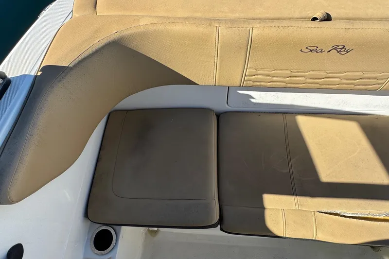 Slide: The Image of 2022 Sea Ray SPX 190 Outboard boat interior with tan seating and logo. - 23