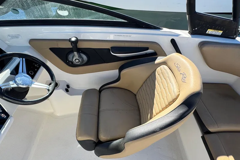 Slide: The Image of 2022 Sea Ray SPX 190 Outboard boat interior with steering wheel and beige seating. - 26