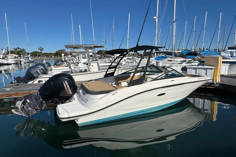 Slide: The Image of 2022 Sea Ray SPX 190 Outboard boat docked in a marina, clear blue sky. - 3