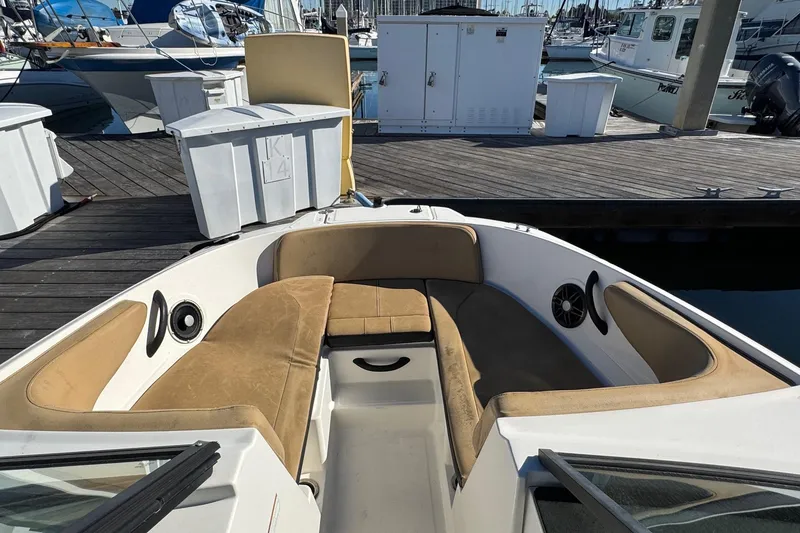 Slide: The Image of 2022 Sea Ray SPX 190 Outboard boat interior with tan seating at marina dock. - 35