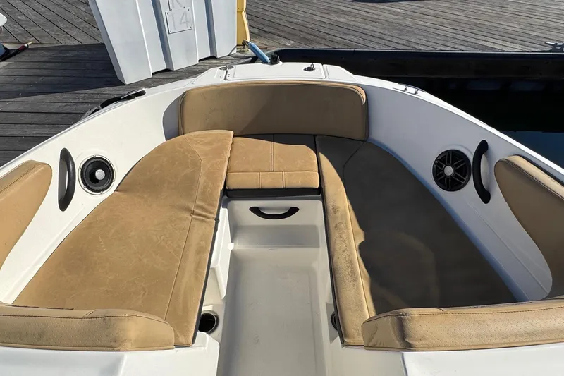Slide: The Image of 2022 Sea Ray SPX 190 Outboard boat interior with tan seating and speakers. - 36