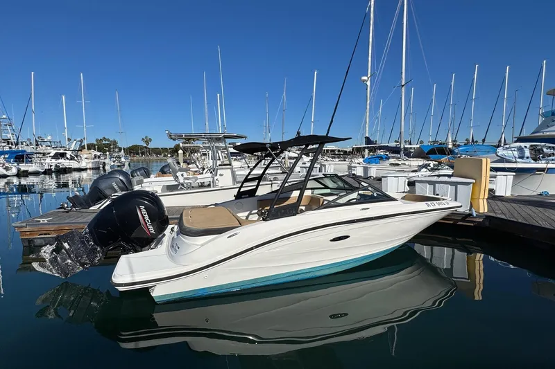 Slide: The Image of 2022 Sea Ray SPX 190 Outboard boat docked in a marina, clear blue sky. - 4