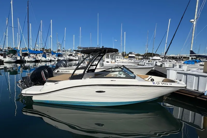 Slide: The Image of 2022 Sea Ray SPX 190 Outboard boat docked in a marina with clear blue skies. - 6