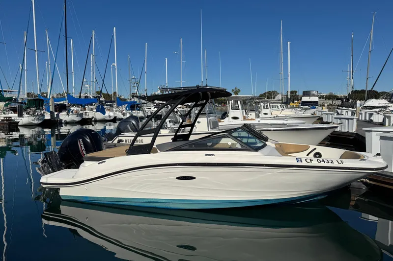 Slide: The Image of 2022 Sea Ray SPX 190 Outboard boat docked in a marina with sailboats. - 7