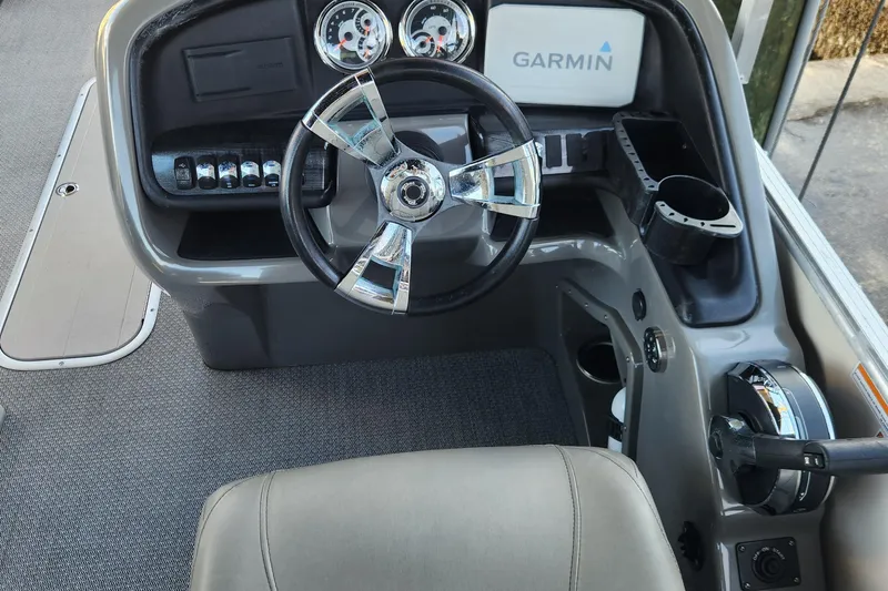 Slide: The Image of 2022 Tahoe Tritune 2585 ENT boat dashboard with Garmin navigation system and modern controls. - 11
