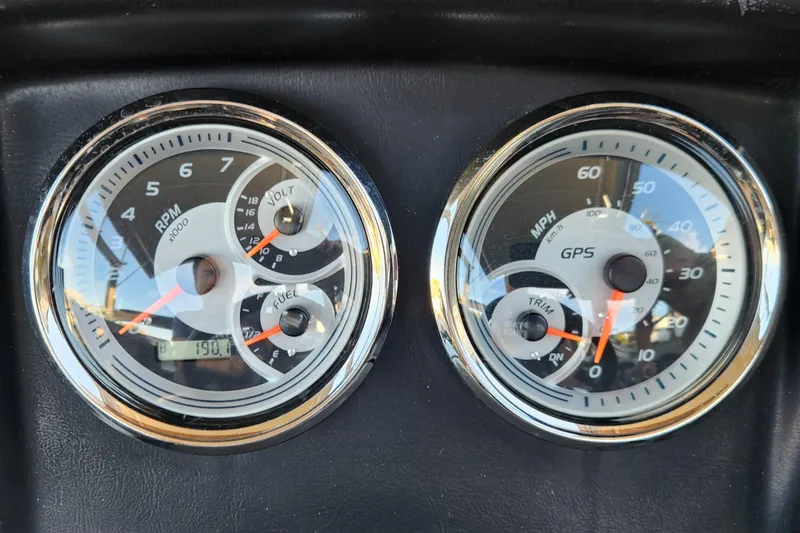 Slide: The Image of Close-up of 2022 Tahoe Tritune 2585 ENT dashboard gauges displaying RPM and speed. - 14