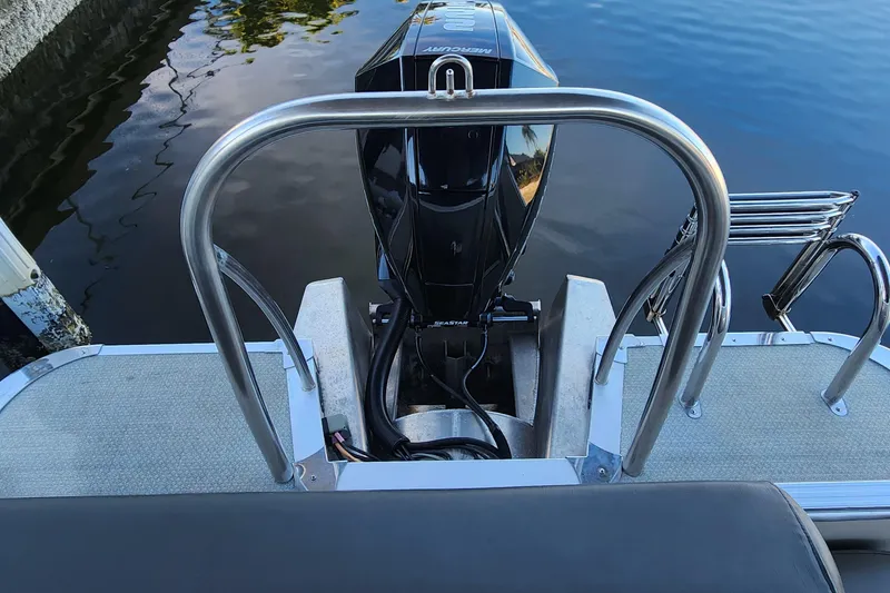 Slide: The Image of 2022 Tahoe Tritune 2585 ENT boat with outboard motor and stainless steel railing. - 19