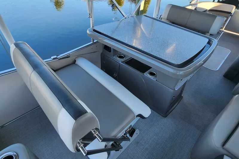 Slide: The Image of Interior of 2022 Tahoe Tritune 2585 ENT boat with seating and table setup. - 32