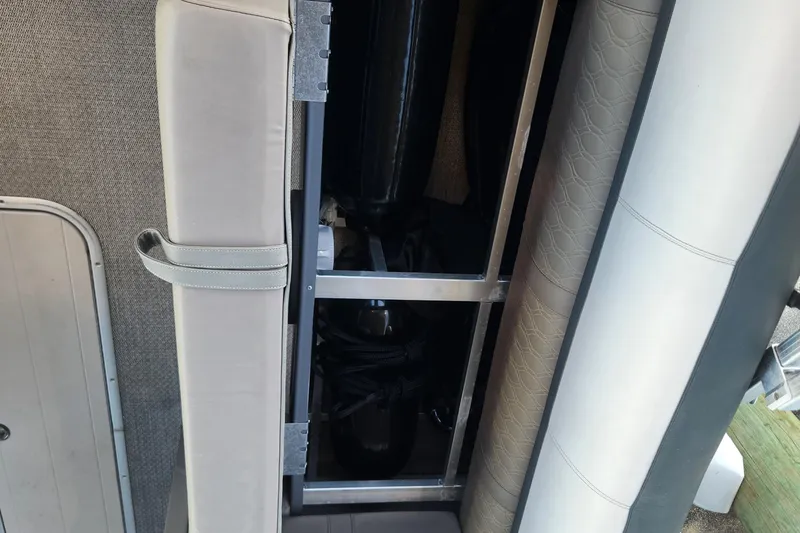 Slide: The Image of Interior view of 2022 Tahoe Tritune 2585 ENT boat, showcasing seating and storage area. - 33
