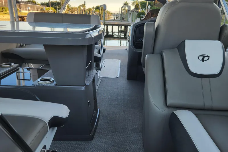 Slide: The Image of Interior of 2022 Tahoe Tritune 2585 ENT boat with sleek seating and table design. - 39