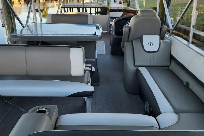 Slide: The Image of Interior of 2022 Tahoe Tritune 2585 ENT pontoon boat with luxurious seating and table. - 40