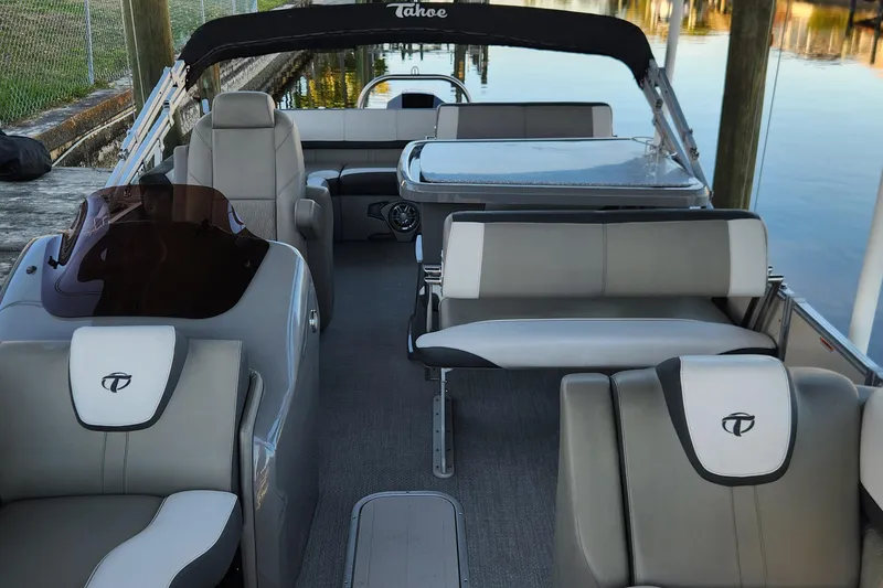 Slide: The Image of 2022 Tahoe Tritune 2585 ENT pontoon boat interior with luxurious seating and sleek design. - 45