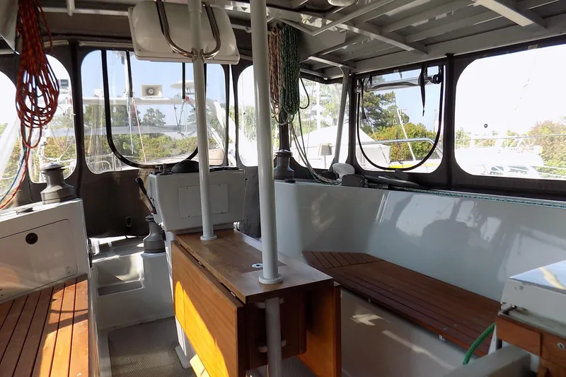 Slide: The Image of Interior of 2014 Custom Aluminum Expedition boat with wooden benches and large windows. - 28