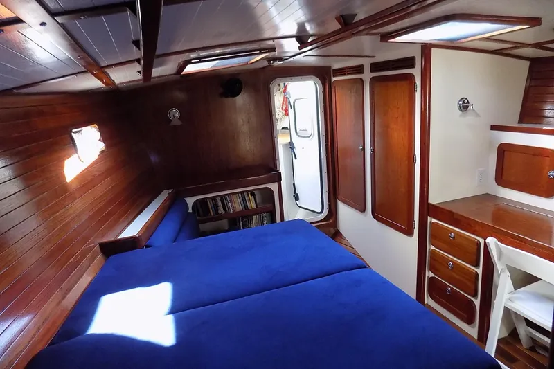 Slide: The Image of Cozy cabin interior of 2014 Custom Aluminum Expedition with wood paneling and blue bedding. - 34
