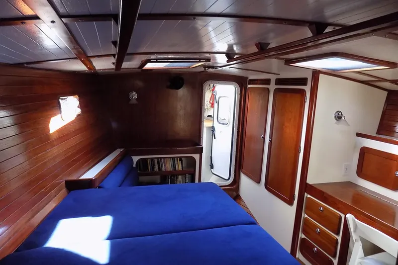 Slide: The Image of Cozy cabin interior of 2014 Custom Aluminum Expedition boat with wooden paneling and blue bedding. - 35