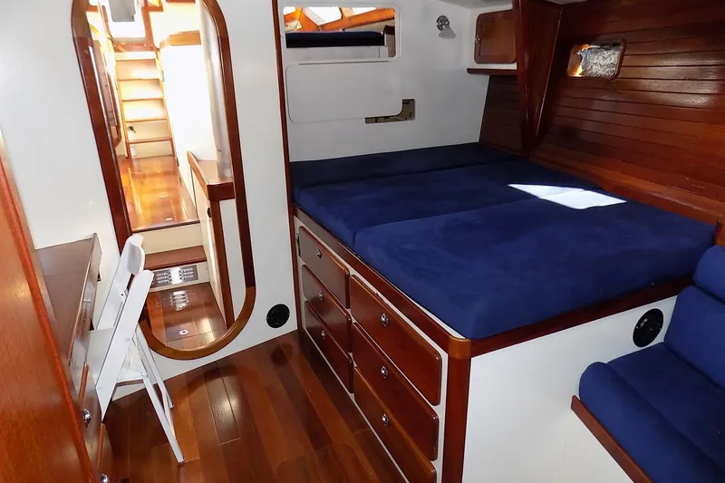 Slide: The Image of Cozy cabin interior of 2014 Custom Aluminum Expedition yacht with blue bedding and wooden accents. - 37