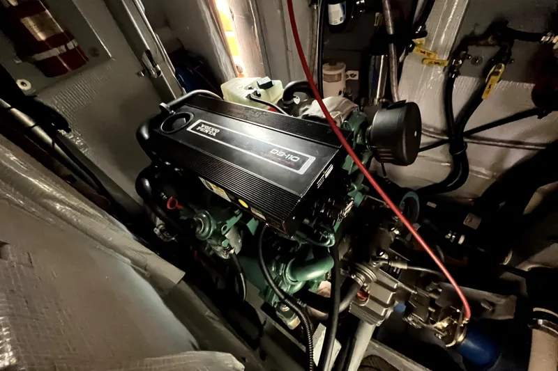 Slide: The Image of Engine compartment of a 2014 Custom Aluminum Expedition boat, featuring a Volvo Penta D5-10 engine. - 46