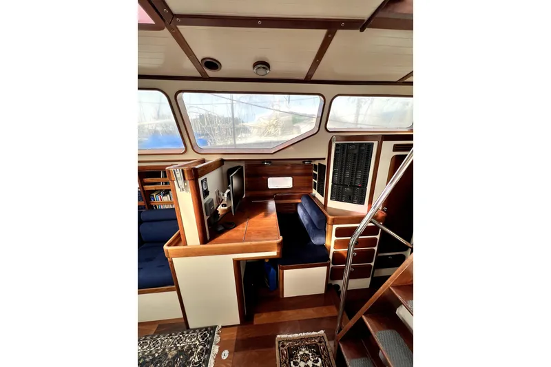 Slide: The Image of Sailboat "Custom Aluminum Expedition 2014" with tall mast against clear blue sky. - 5