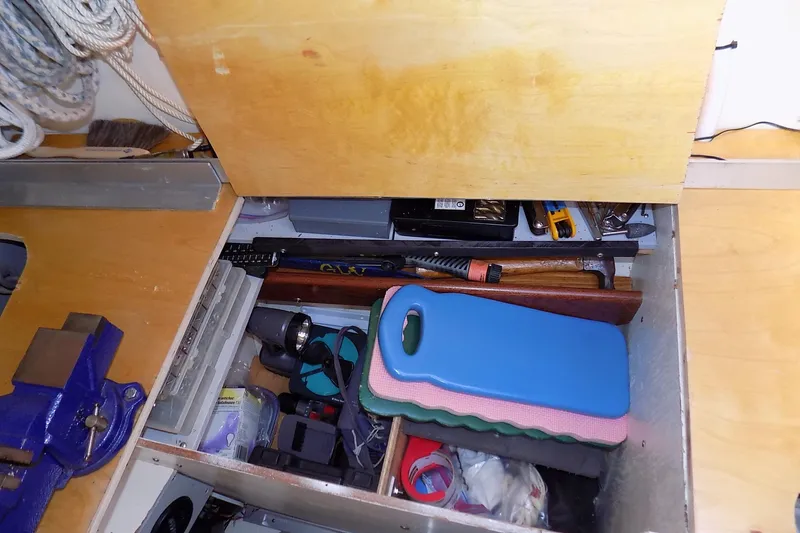 Slide: The Image of Storage compartment in a 2014 Custom Aluminum Expedition, containing tools and equipment. - 56