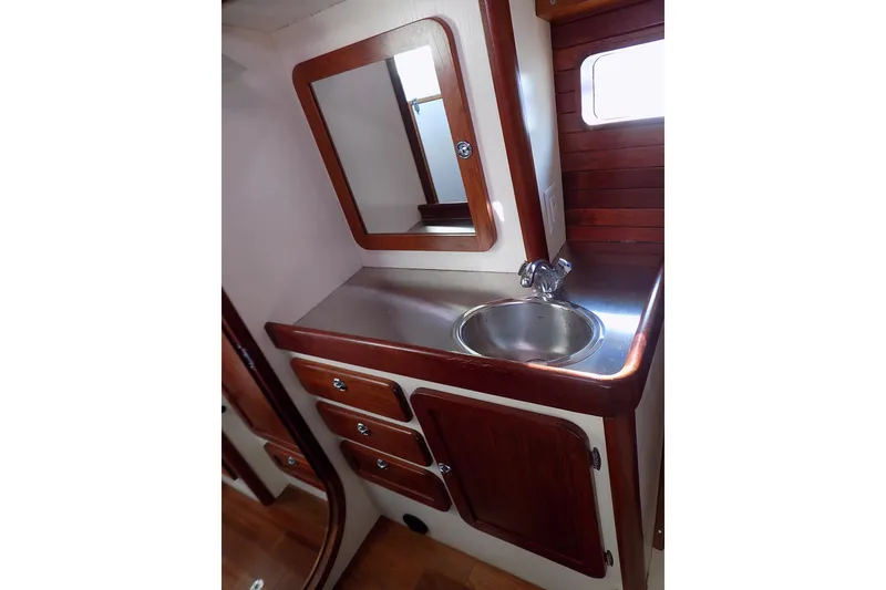 Slide: The Image of 2014 Custom Aluminum Expedition yacht bathroom with wood accents and stainless steel sink. - 63