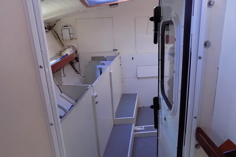 Slide: The Image of Laundry area in 2014 Custom Aluminum Expedition with washer, storage drawers, and electrical panels. - 66