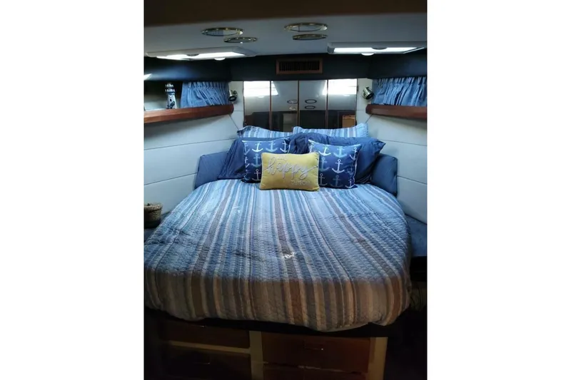 Slide: The Image of Cozy bedroom in 1991 Bayliner 4588 Pilothouse with nautical-themed bedding. - 10