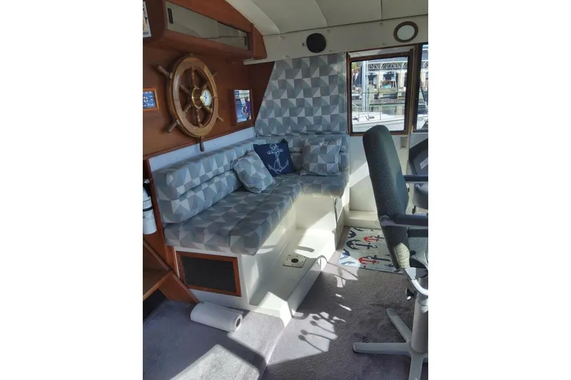 Slide: The Image of Interior of 1991 Bayliner 4588 Pilothouse with geometric seating and nautical decor. - 11
