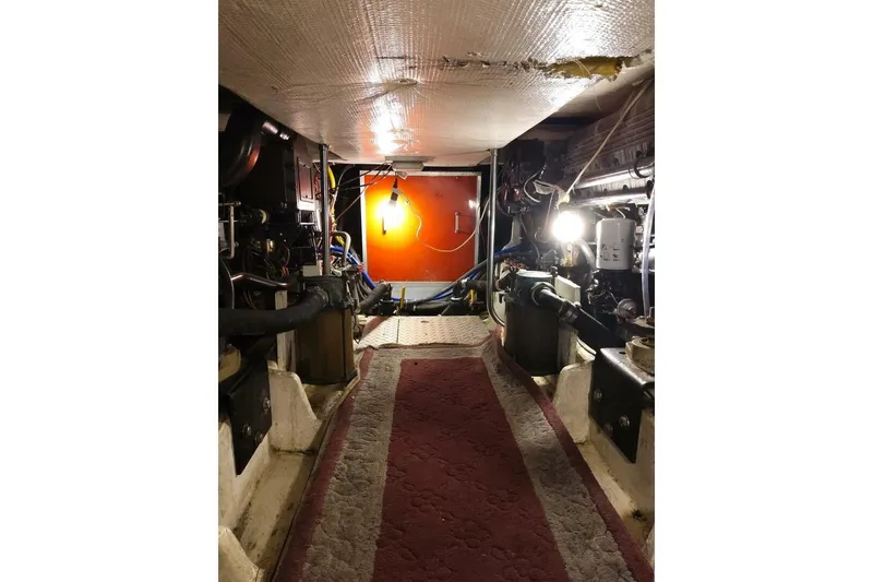 Slide: The Image of Engine room of 1991 Bayliner 4588 Pilothouse with visible machinery and lighting. - 12