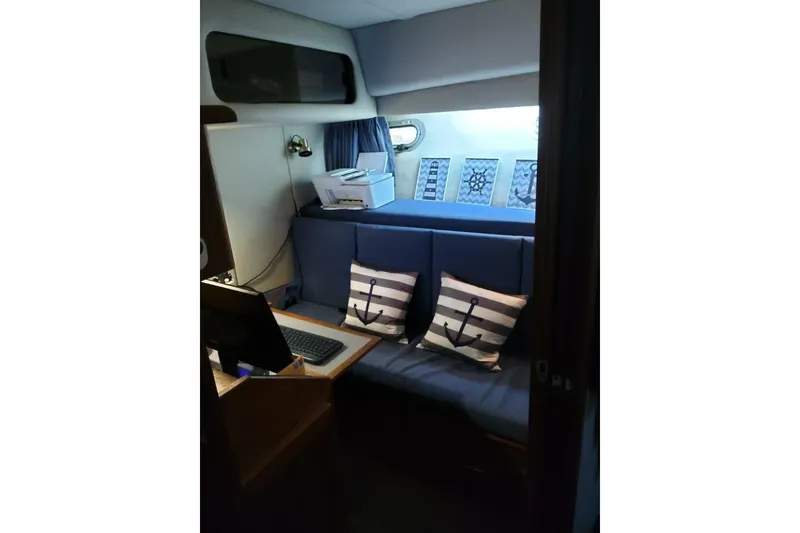 Slide: The Image of Cozy interior of 1991 Bayliner 4588 Pilothouse with nautical-themed decor and seating. - 13
