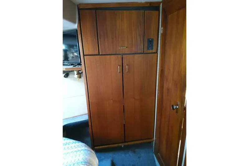 Slide: The Image of 1991 Bayliner 4588 Pilothouse interior with wooden cabinetry and door. - 15