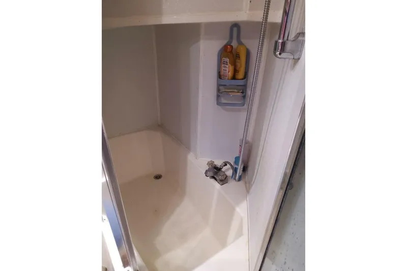 Slide: The Image of Shower area in 1991 Bayliner 4588 Pilothouse yacht with toiletries and fixtures. - 17