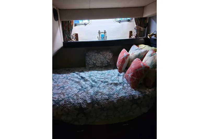 Slide: The Image of Cozy cabin interior of 1991 Bayliner 4588 Pilothouse with decorative pillows and bedding. - 18