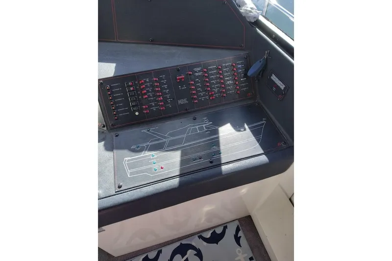 Slide: The Image of 1991 Bayliner 4588 Pilothouse control panel with switches and diagram. - 24