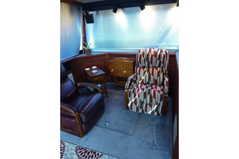 Slide: The Image of Interior of 1991 Bayliner 4588 Pilothouse with comfortable seating and wooden accents. - 8